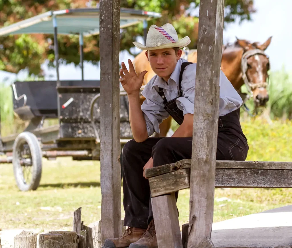 why visit belize friendly people mennonite waving